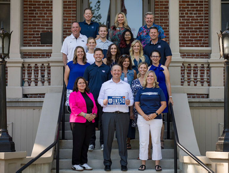 University of Nevada, Reno, Alumni Association Board members pose with license plate #150 of the Great98.